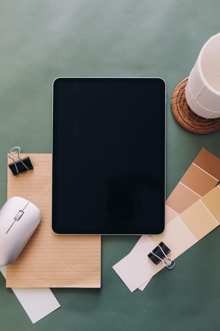 Remote work essentials including laptop, coffee, and notebook